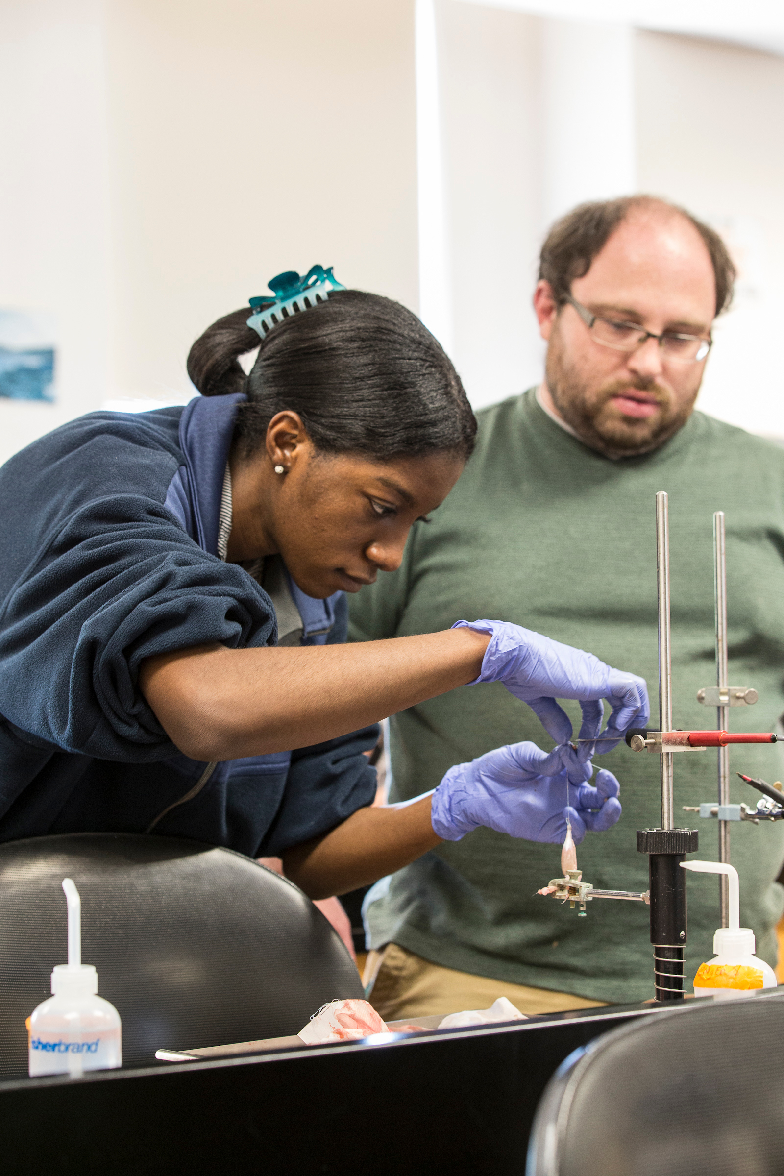 A student and professor work in a lab together.