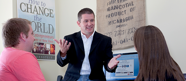 Professor speaking to two students