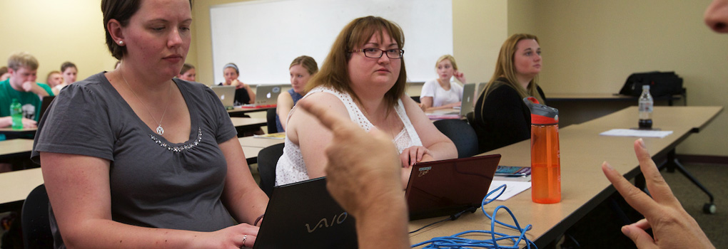 ASL Interpreter helping a student and professor communicate in class