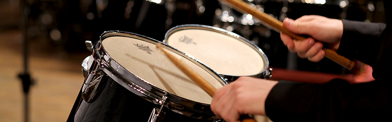 student playing the drums