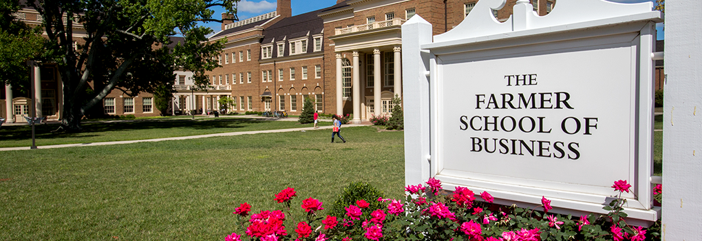Farmer School of Business sign flanked by summertime flowers