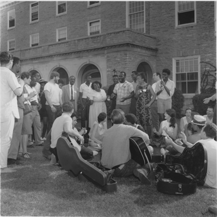  Freedom Summer volunteers sitting on the lawn and sitting