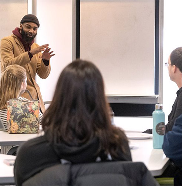 Three panels of photos. First, at left, a man, gesturing, speaks to a workshop audience. Second, middle, three students with laptops work at a table in front of a wall with the HOWE name on Third, at right, a young woman works on laptop.