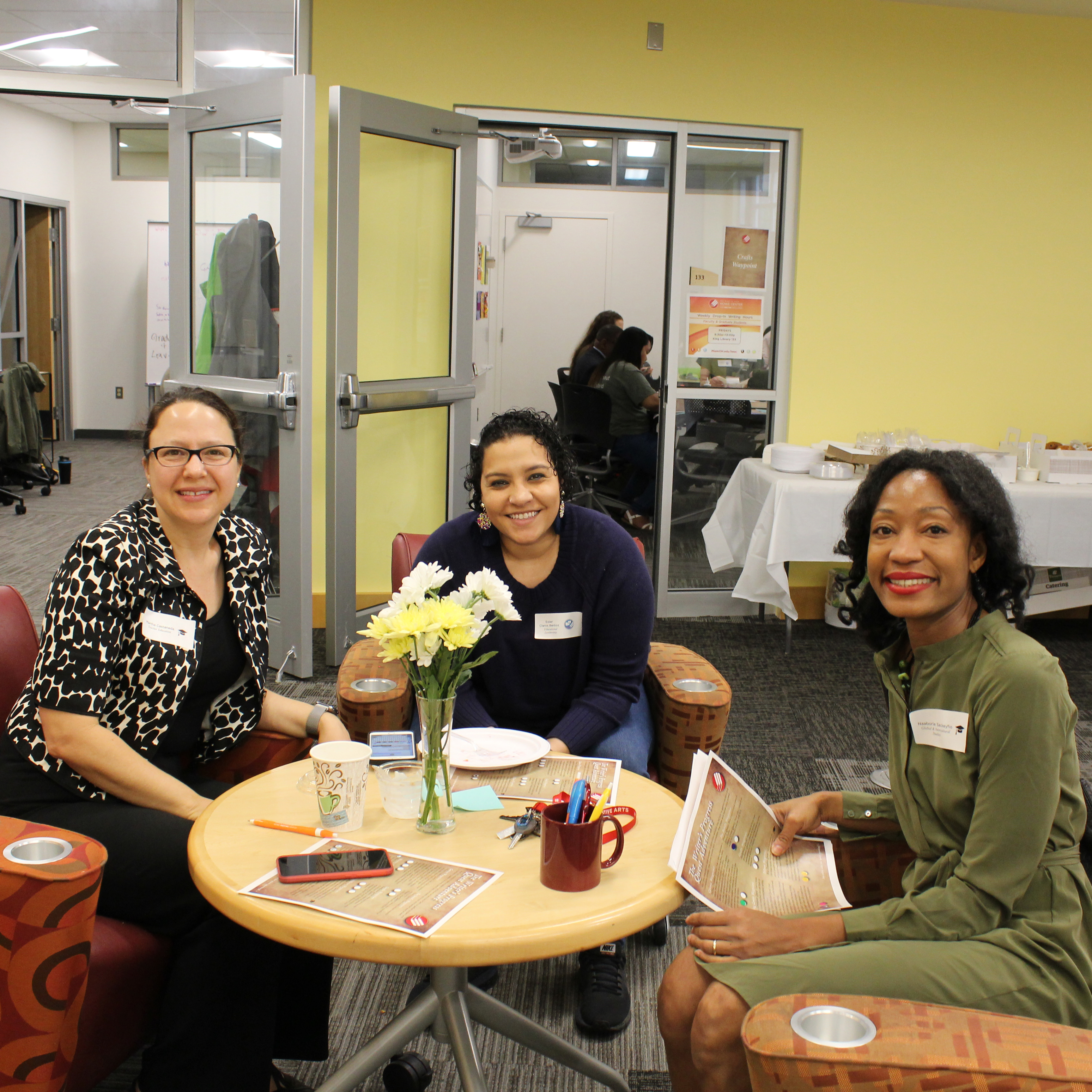 3 faculty members seated in the Howe Center for Writing Excellence.