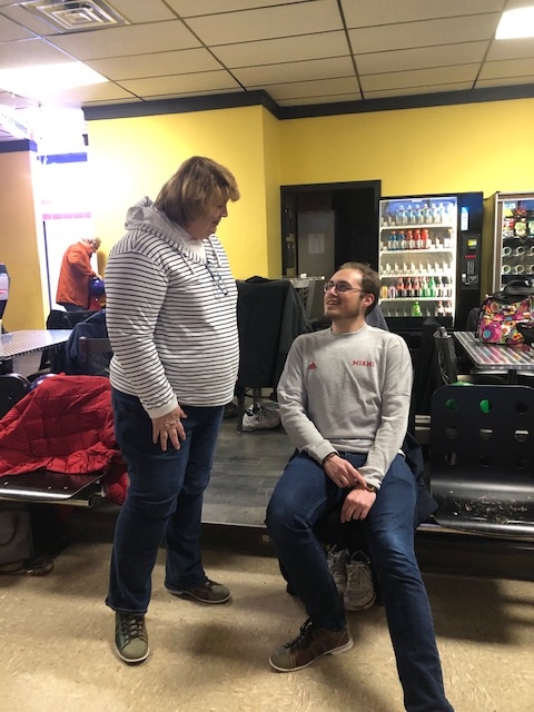 Cindy Hurley talking to a student employee at Oxford Lanes bowling alley