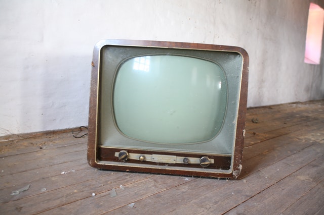 Old TV sitting on a wood table