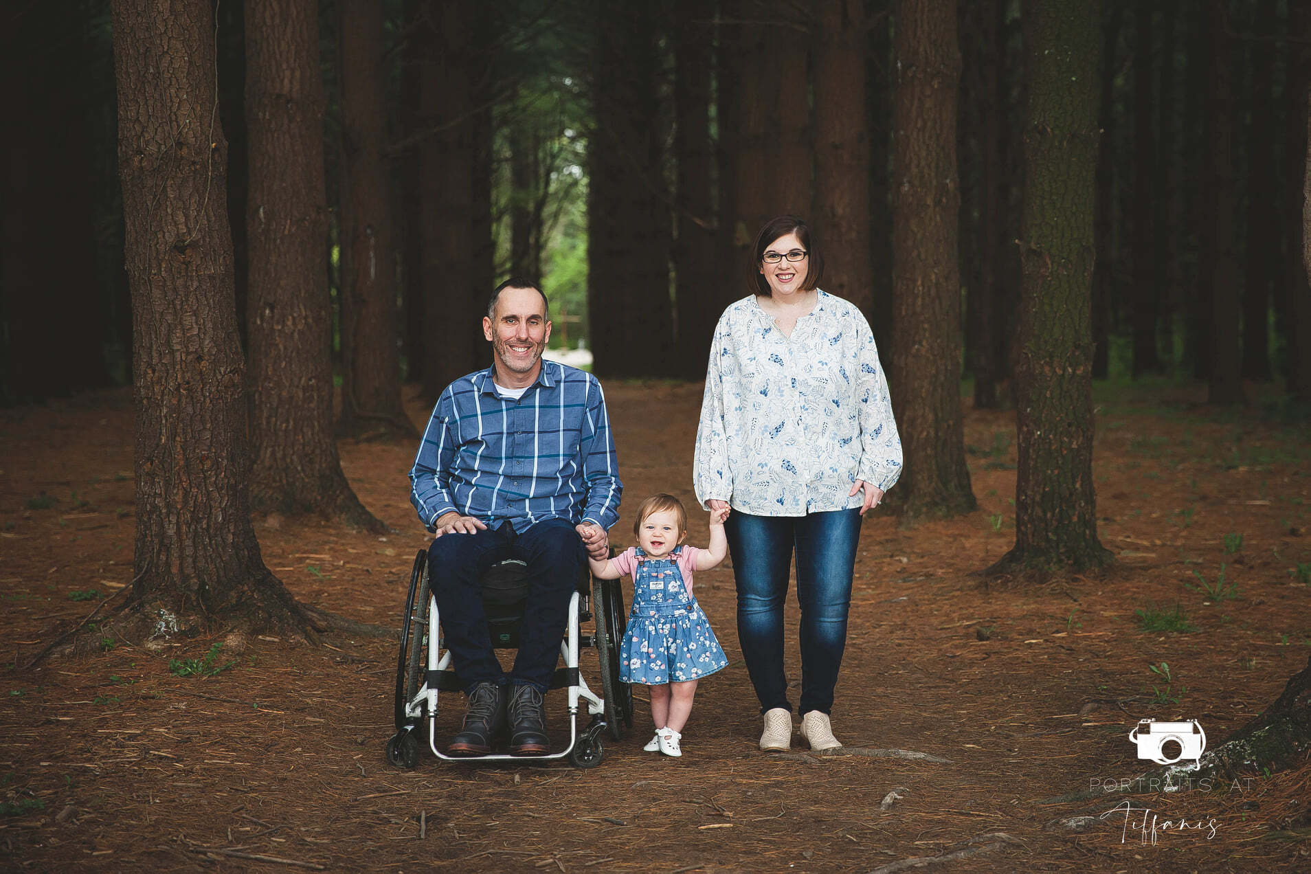 Matt Striet, in the wheelchair at left, with his wife (far right) and one-year-old daughter between them