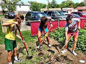 Rachel Goddard, Nicole Anderson and Jillian Spurlock, incoming first-year students and members of Miami's women's basketkball team, tended the garden at Oxford's Family Resource Center.