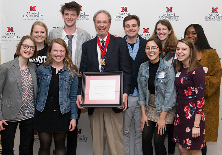 Richard Campbell, shown here with his students, received Miami's highest honor, the Benjamin Harrison Medallion, at a ceremony March 19.