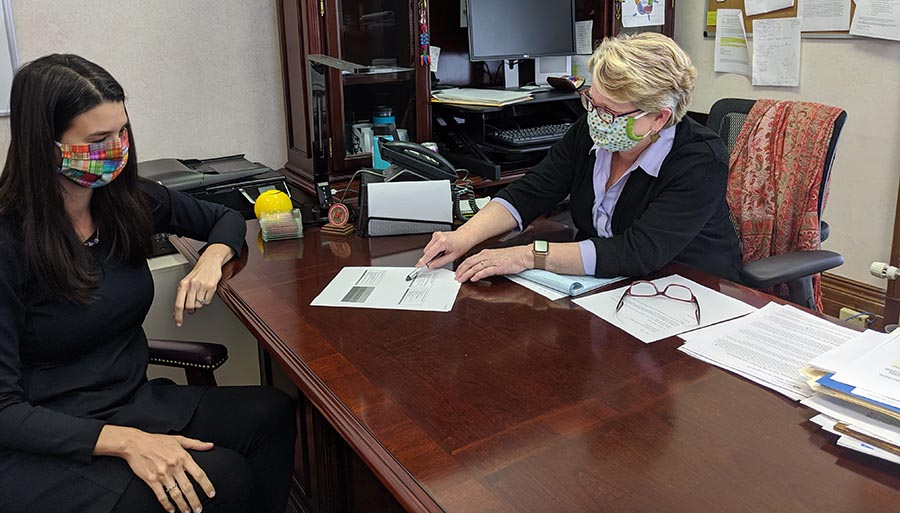 Kendall Leser (left), director of Miami's public health program, works with Jennifer Bailer (Miami '81), Butler County health commissioner.