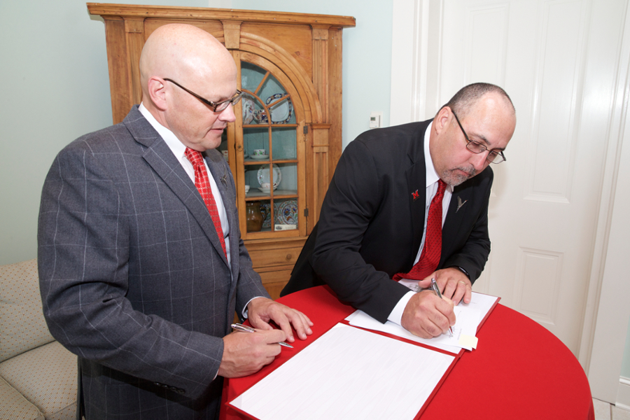 Miami University’s President Gregory Crawford and Miami Tribe of Oklahoma Chief Douglas Lankford sign the 2017 Memorandum of Agreement creating the Myaamia Heritage Logo, a jointly owned logo between the Tribe and University that represents the relationship between the two partners.