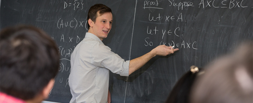  A math instructor works through a calculation on the chalkboard