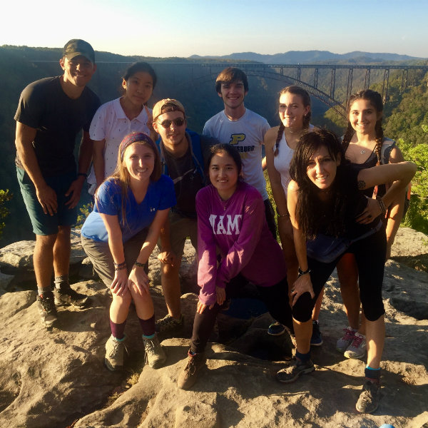 students together smiling on a mountainside