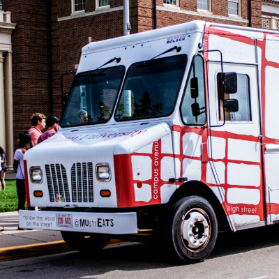 Photo of the strEATS Food Truck parked outside of Farmer School of Business serving students