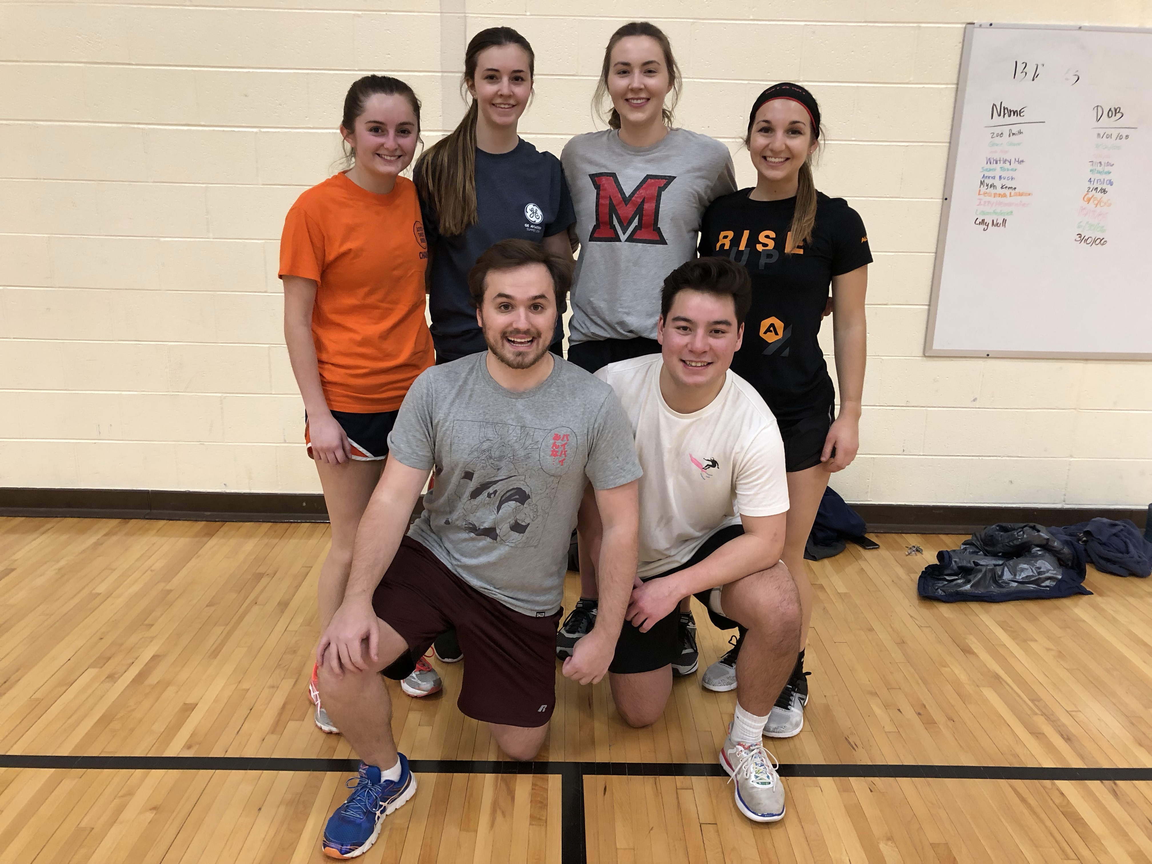 Indoor Co-Rec Volleyball runner up team poses on the court.