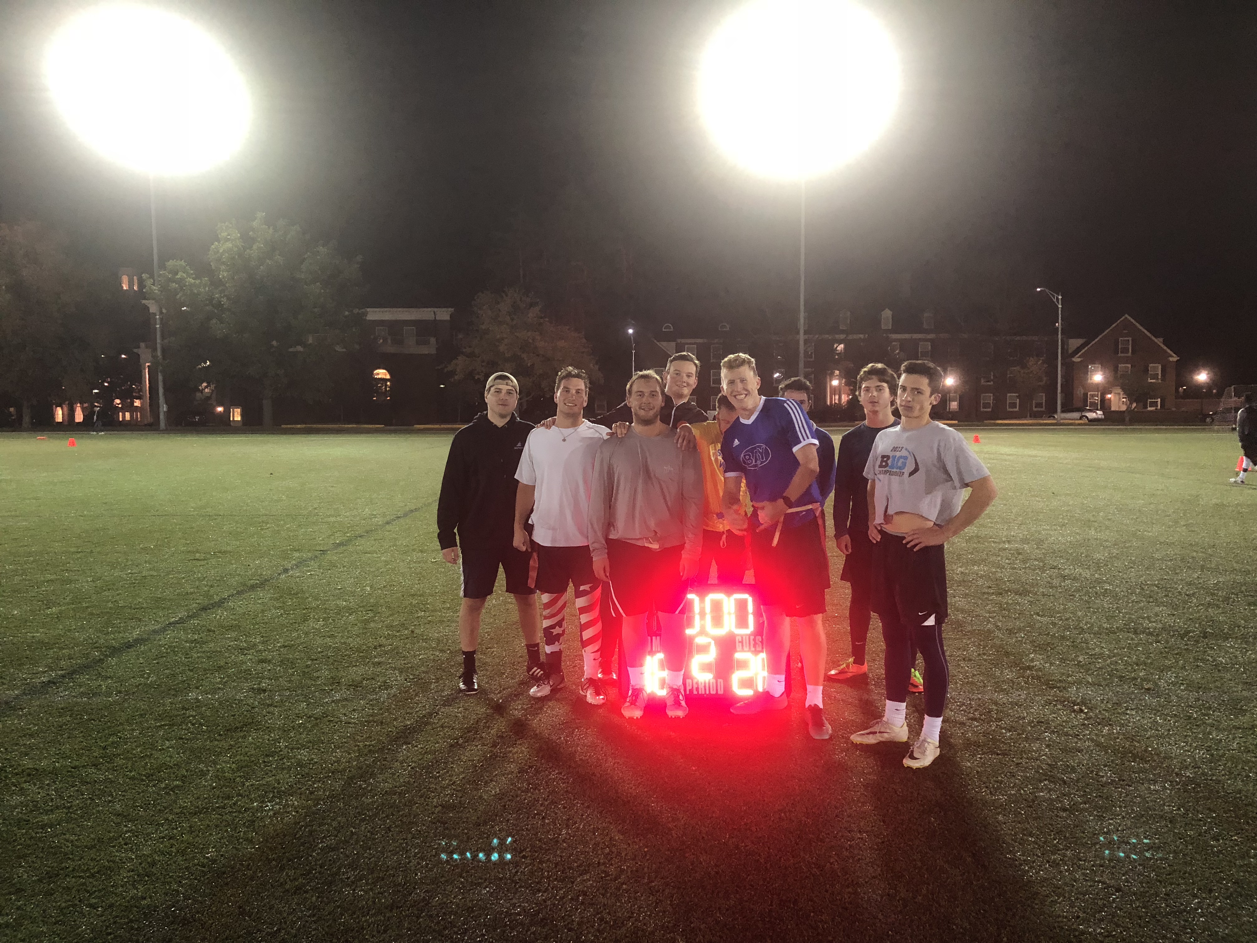  Flag football runner up team poses for a photo by the final game scoreboard.