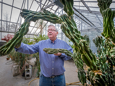 Jack Keegan, past Manager of Belk Greenhouse, shows off a cactus.