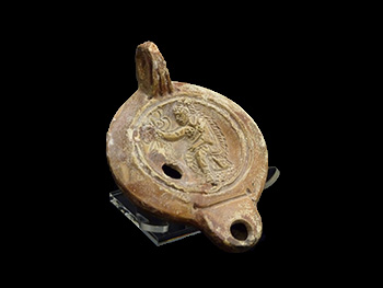 Roman oil lamp with warrior wearing a headdress