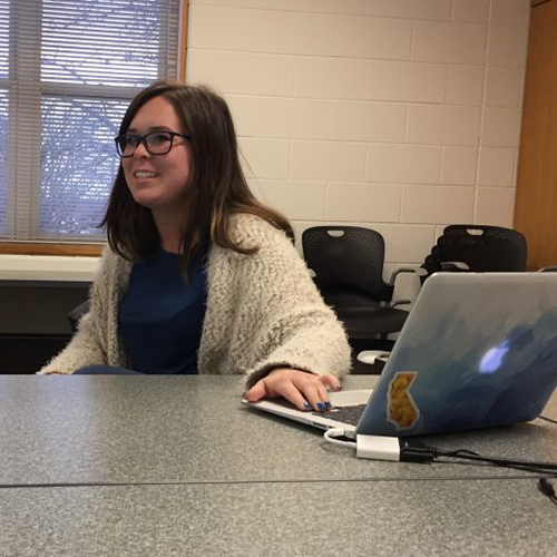 A student uses her laptop to present on her internship experiences