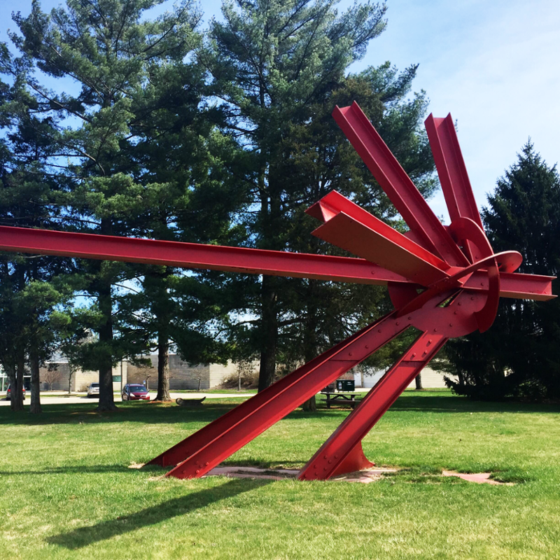 The red Kepler sculpture on the lawn of the Art Museum