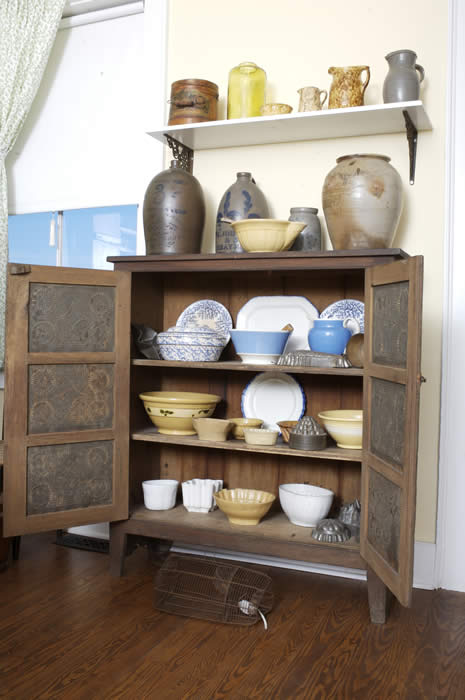 Pie Safe Cupboard displaying dishes and cookware
