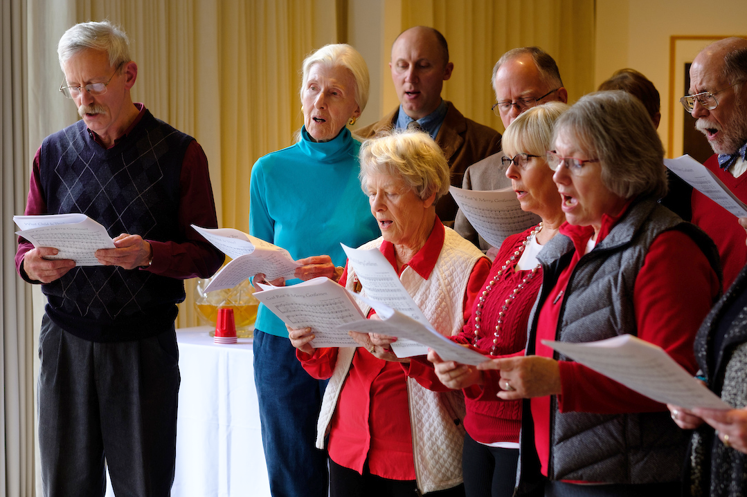 Closeup of singers holding song sheets