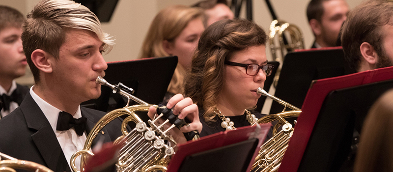 A row of horn players at the Wind Ensemble concert