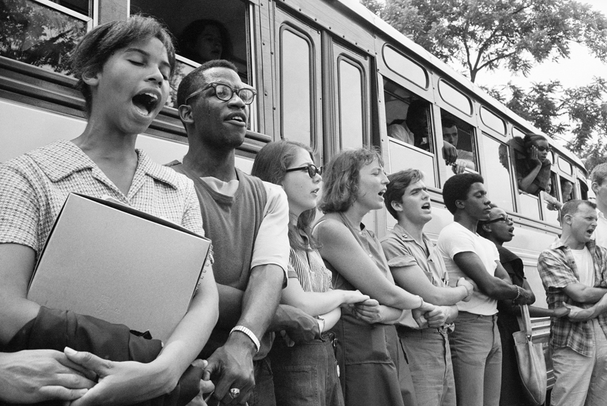 Singing We Shall Overcome, this group of Freedom Summer volunteers begins its journey from Oxford, Ohio to Mississippi. Despite the dangers, more than 1,000 college students volunteered to canvass, teach and establish community centers.