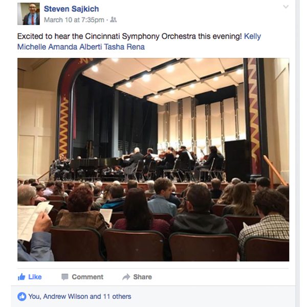 Facebook post by Steven Sajkich, Excited to hear the Cincinnati Symphony Orchestra this evening! Kelly Michelle Amanda Alberti Tasta Rena. Photo of the Symphony warming up on stage while audience sits is seats.