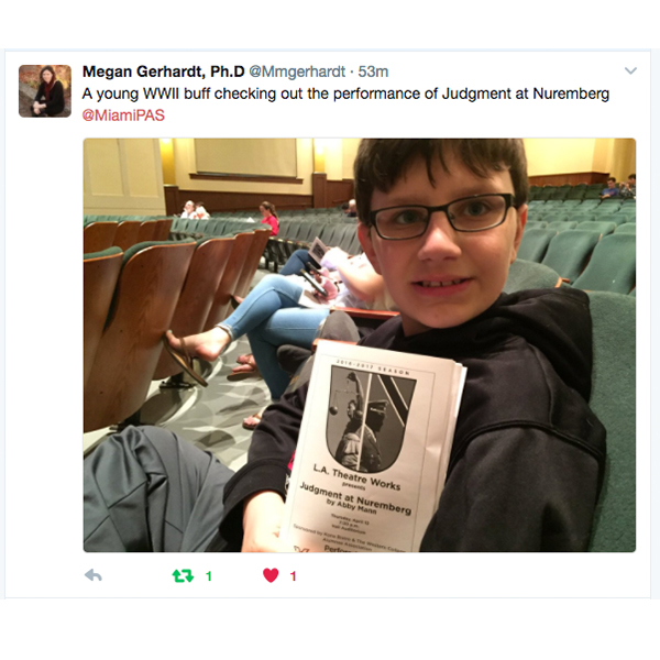 Tweet by @Mmgerhardt, A young WWII buff checking out the performance of Judgment at Nuremberg @MiamiPAS. Photo of boy sitting holding the program for Judgment at Nuremberg in his hands.