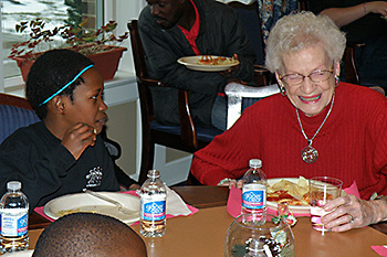 African Children's Choir members dining with Seniors at the Knolls