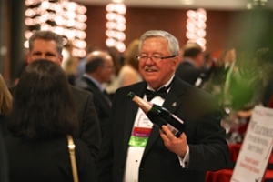 Jack Keegan holds a bottle of wine
