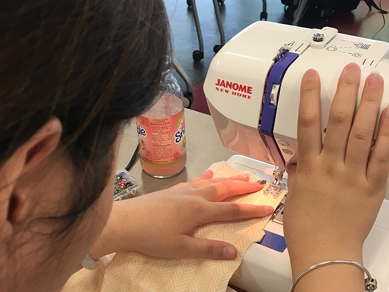 student using sewing machine