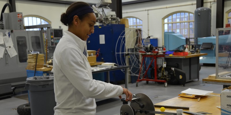 Female student working on metal in MME lab