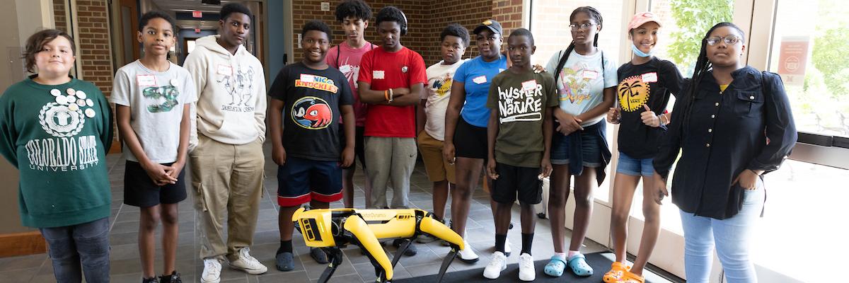  Cincinnati REC Center Outreach students surrounding a Robot Dog
