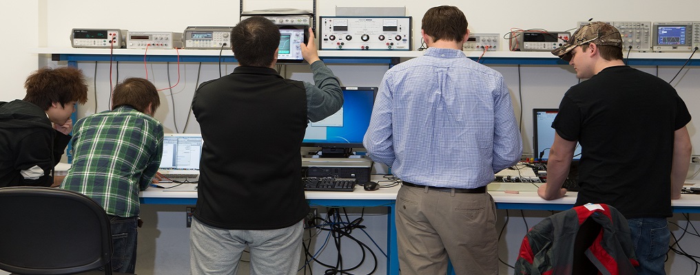Male students working in an electrical engineering classroom