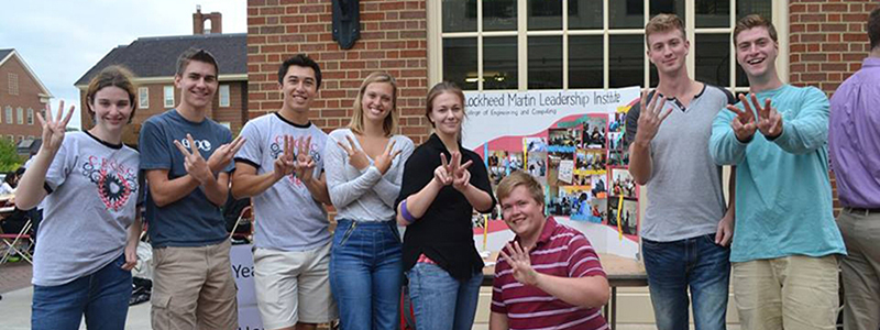  Cohort 4 Members at CEC picnic holding up four fingers