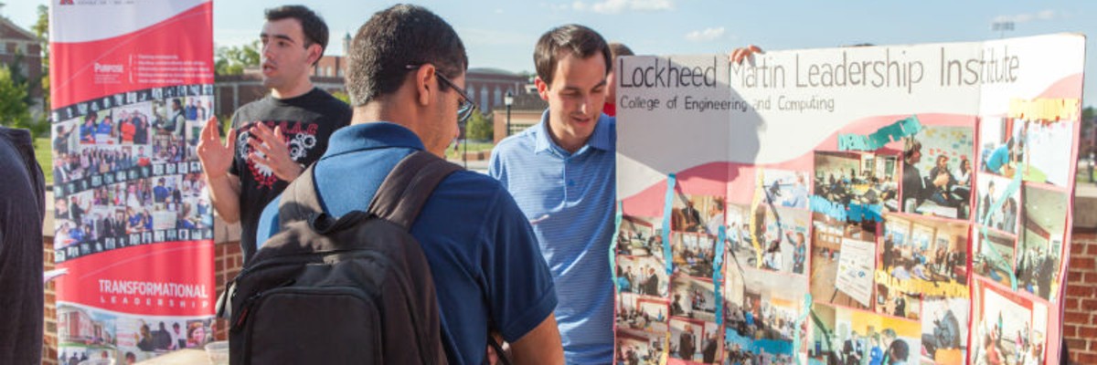 Lockheed Martin Leadership Institute students presenting posters to students at the CEC Picnic