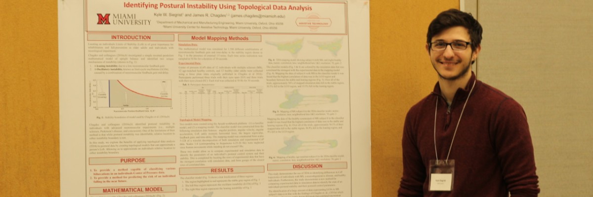 A student giving a presentation using a poster.