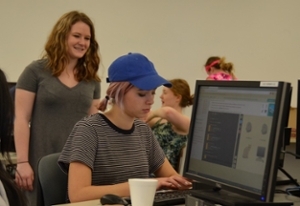Girls Who Code helping high school students code on computers