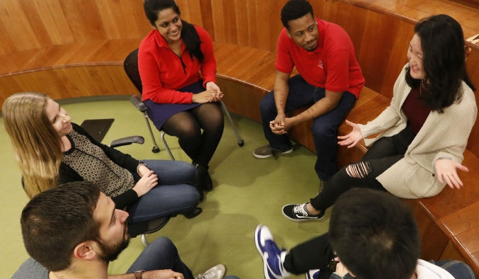 Students seated in a circle engaged in discussion