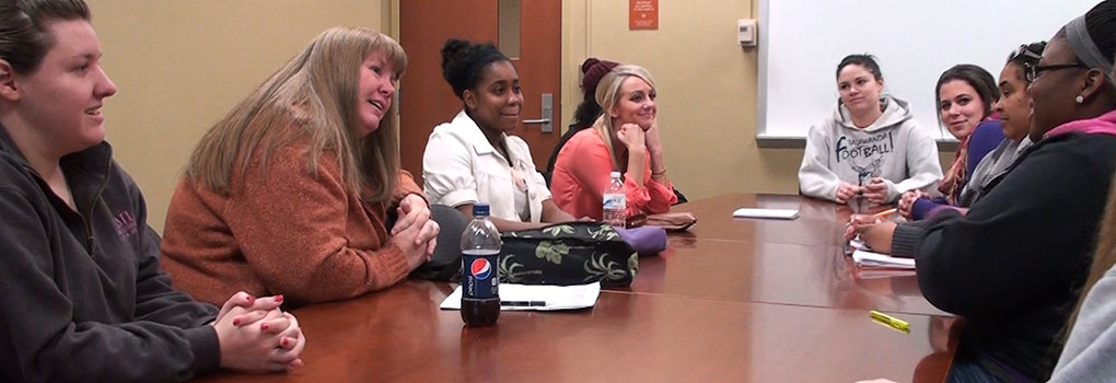 group of people sitting around a table having a discussion