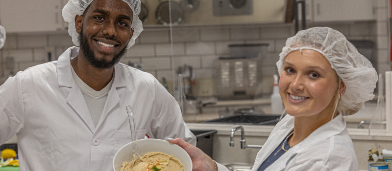 Two nutrition students showing their finished recipe