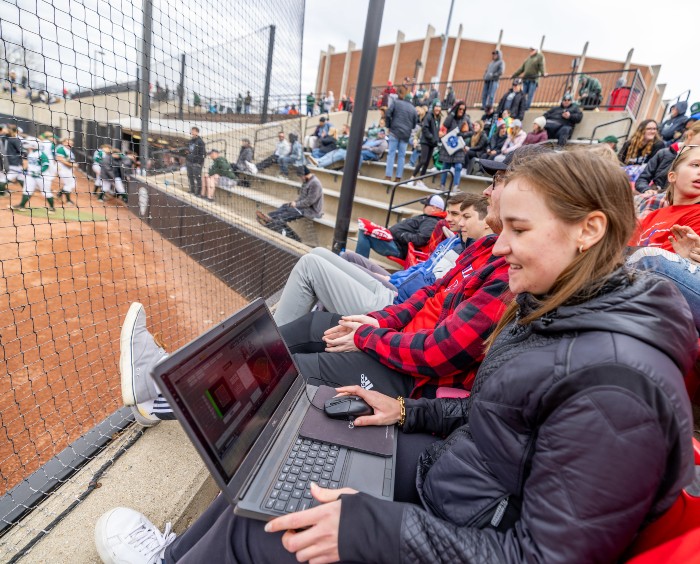 Caroline Brega at baseball game with computer to work on data collection