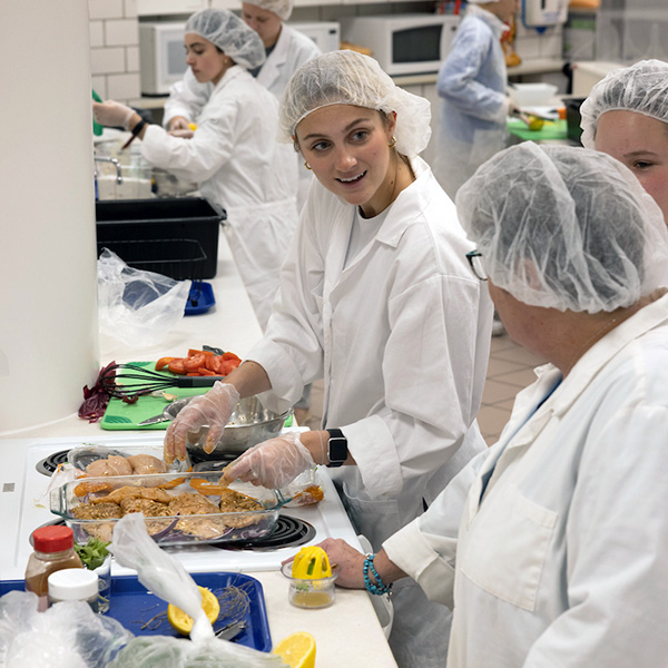 students making food in a lab kitchen
