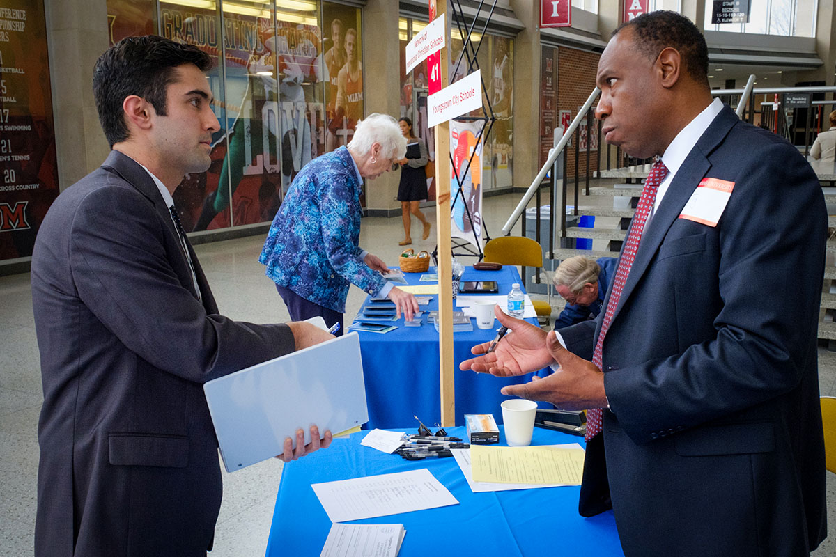 student greeting an employer at a career fair