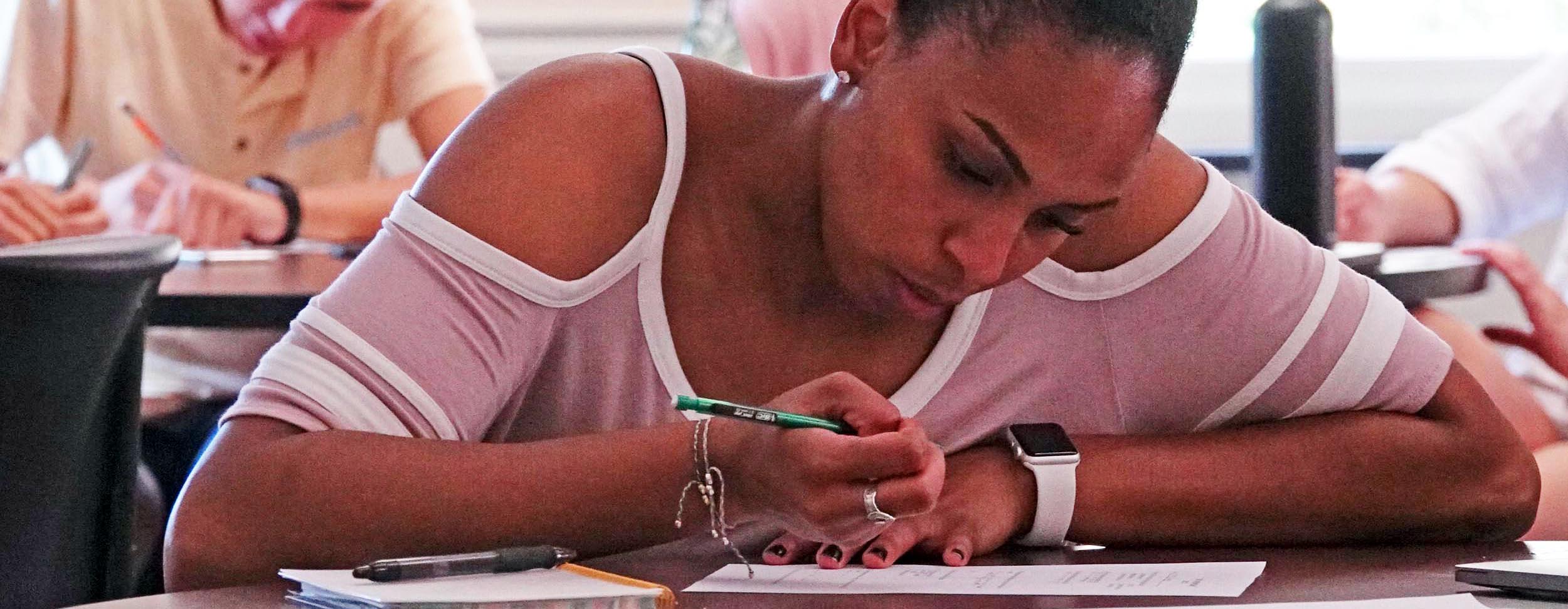 Student fills out form on first day of entrepreneurship class