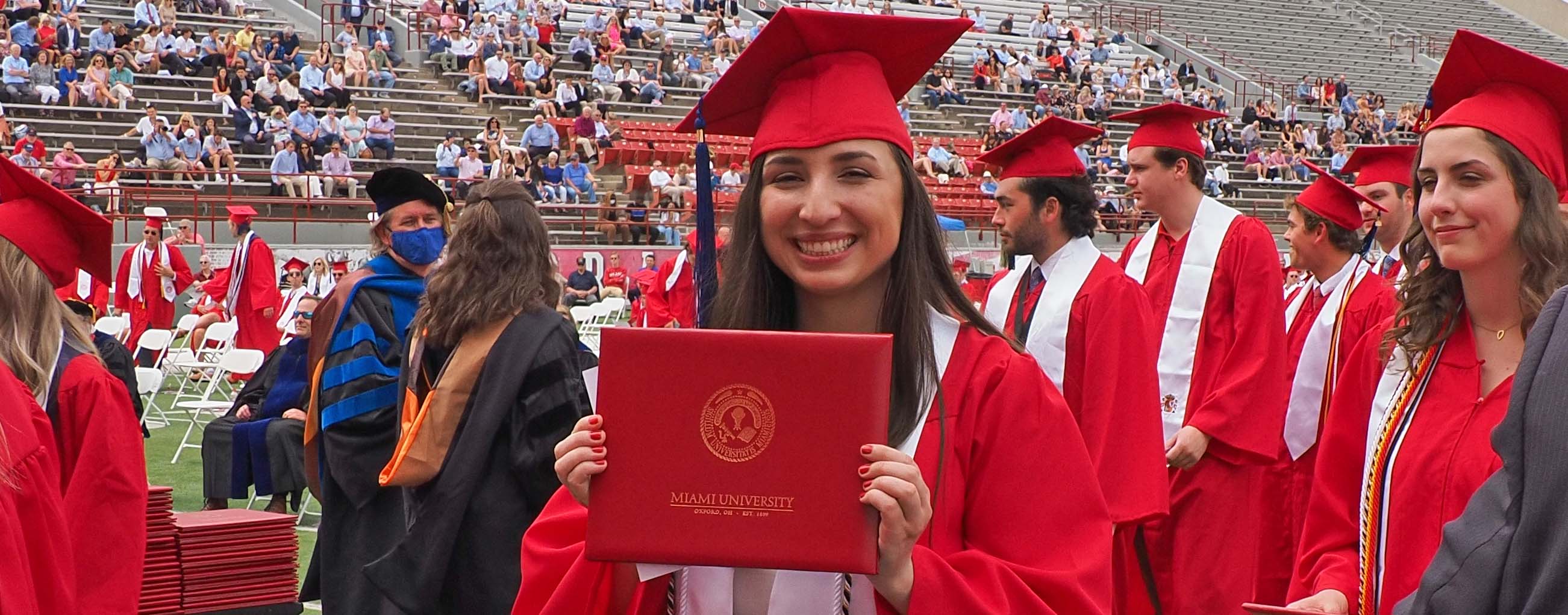 Katie Kopan holding up diploma holder