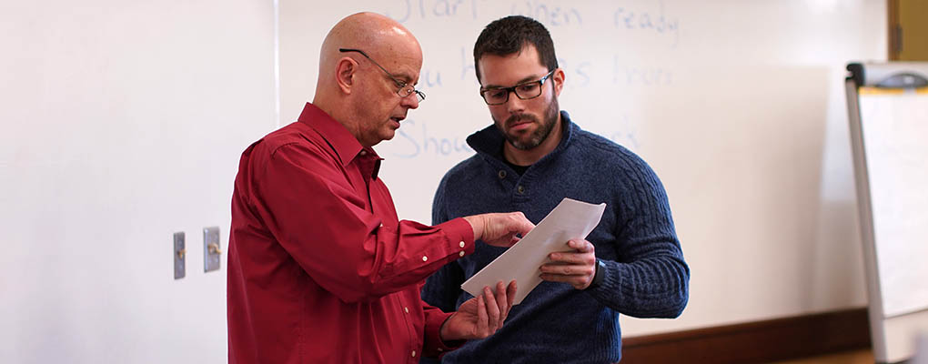 Dr. Terry Nixon talks with a student during an exam