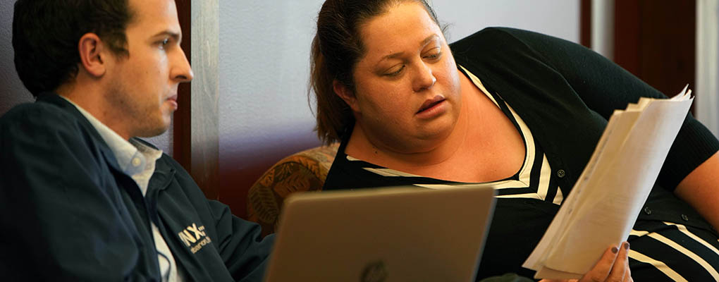Woman consults another student outside exam room